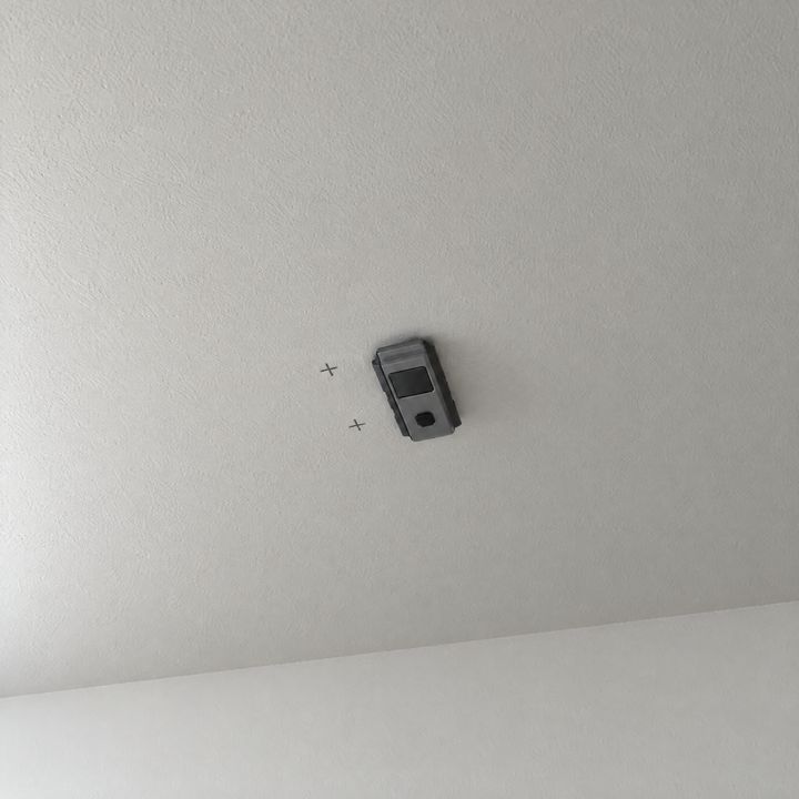 Ein Leitungssucher prüft die Decke rund um die Markierungen.